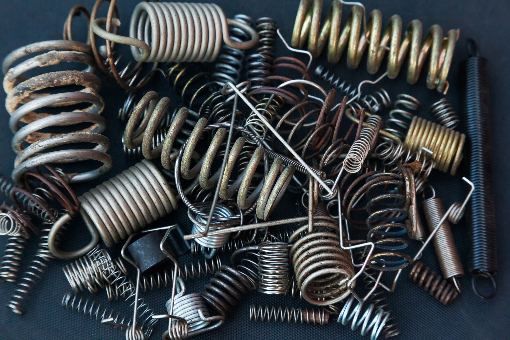 a pile of various springs exhibiting different material types